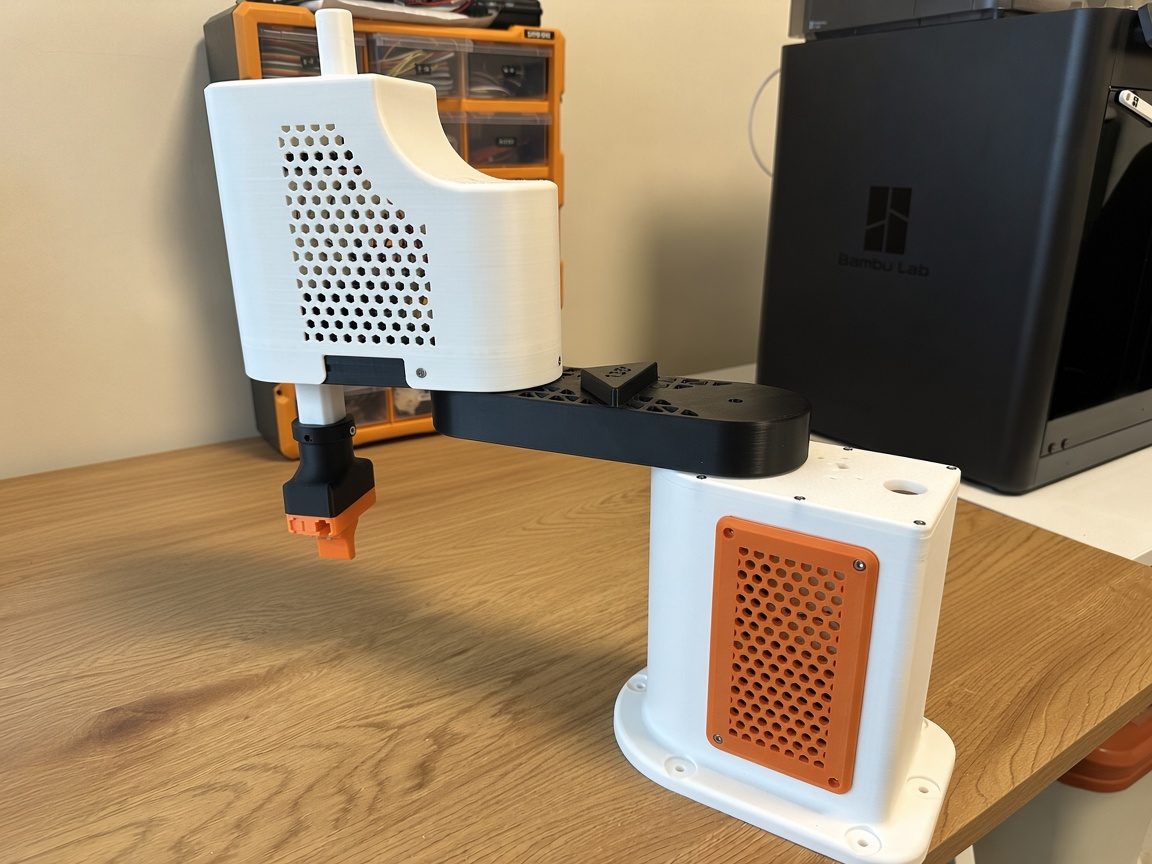 The finished SCARA on the workbench next to a 3D printer